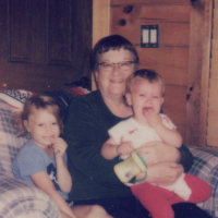 grandmother with 2 kids sitting in a chair from the thrift store