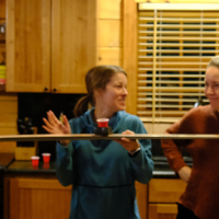 woman drinking from a shotski